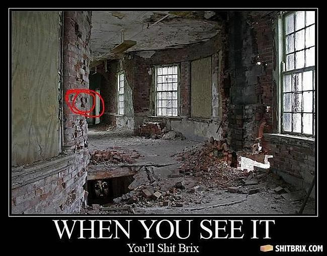 An abandoned room with a red circle on the left wall and a face visible in a dark opening below it