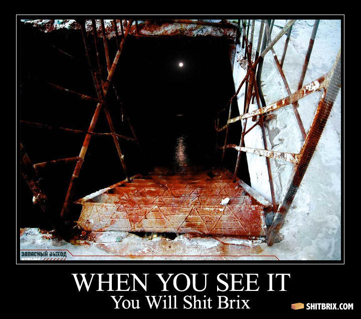 A dark stairwell with a pale face barely visible in the shadows