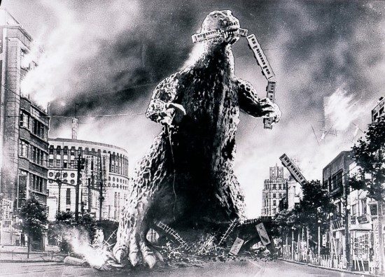 Godzilla towering over a burning city in a black-and-white still